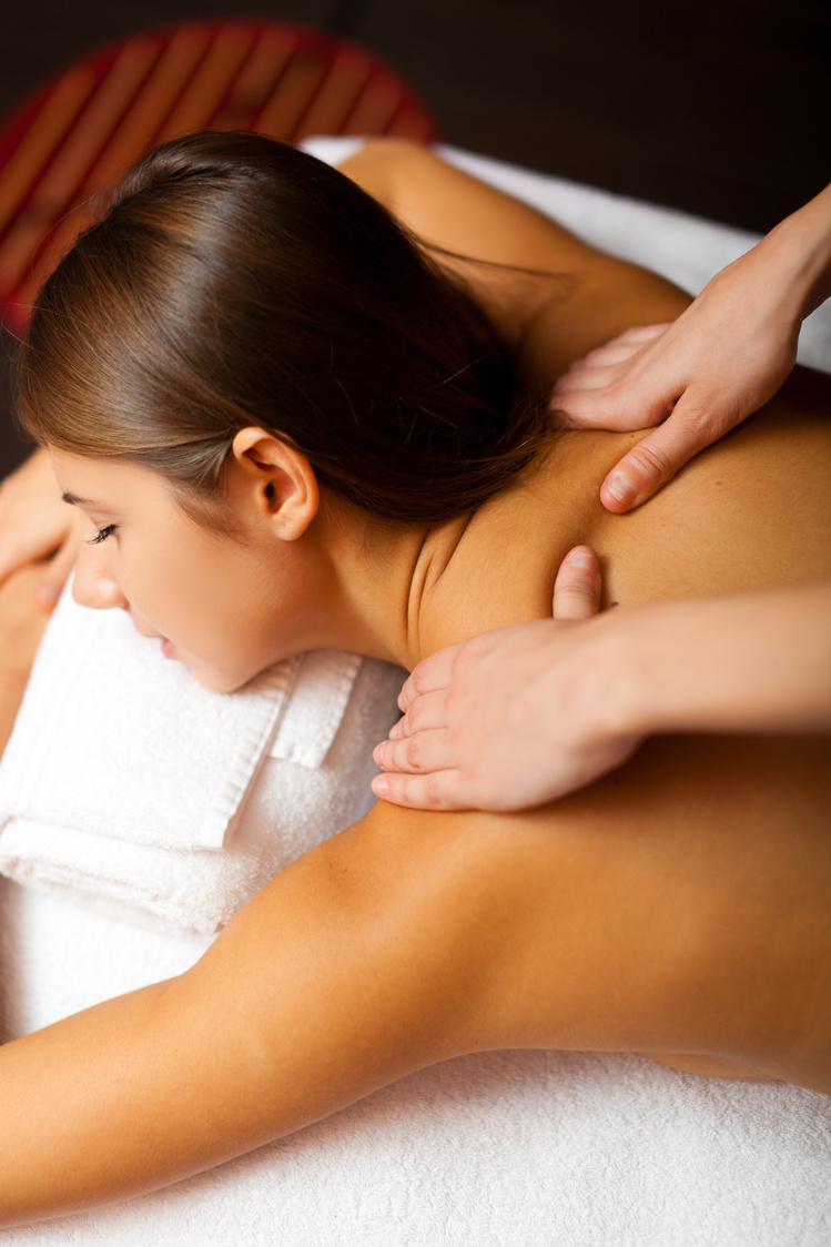 Relaxed Woman Receiving a Massage in a Spa